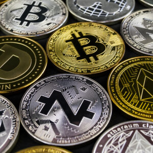 A lot of cryptocurrency coins lie on a dark surface background